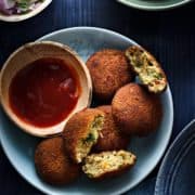 Crispy Chicken Cutlets served on blue plat with sauce on the side