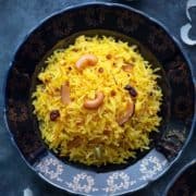 A close-up shot of Zarda pulao (sweet rice) served on a blue plate