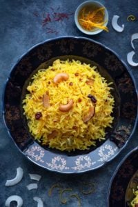 A close-up shot of Zarda pulao (sweet rice) served on a blue plate