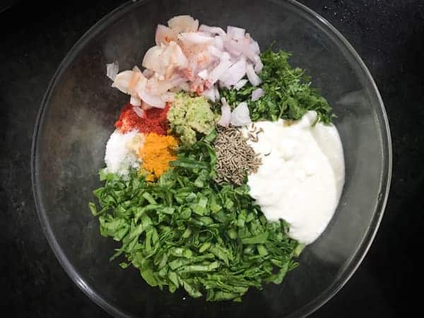 Moong Dal paste and all the ingredients added into a bowl