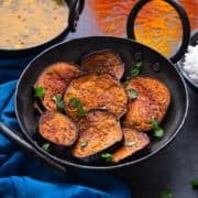 Tawa fried Bengali Begun Bhaja ( baingan fry) in a kadhai (wok)