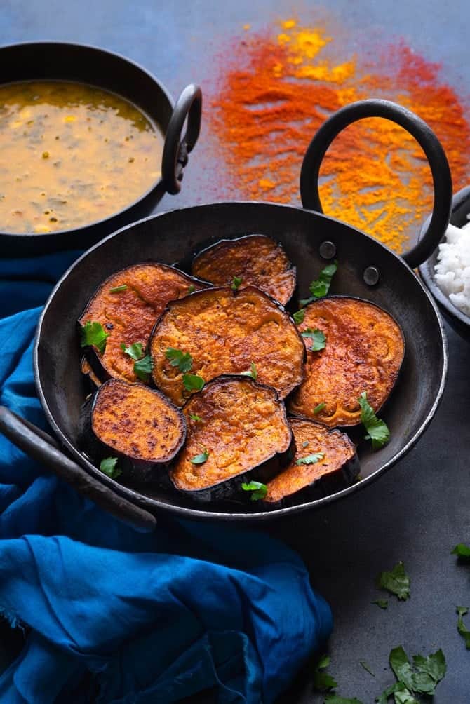 tawa fried Bengali Begun Bhaja ( baingan fry) in a kadhai (wok)