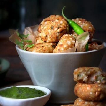 Crispy Sabudana Vada served in a bowl with green chutney on the side.