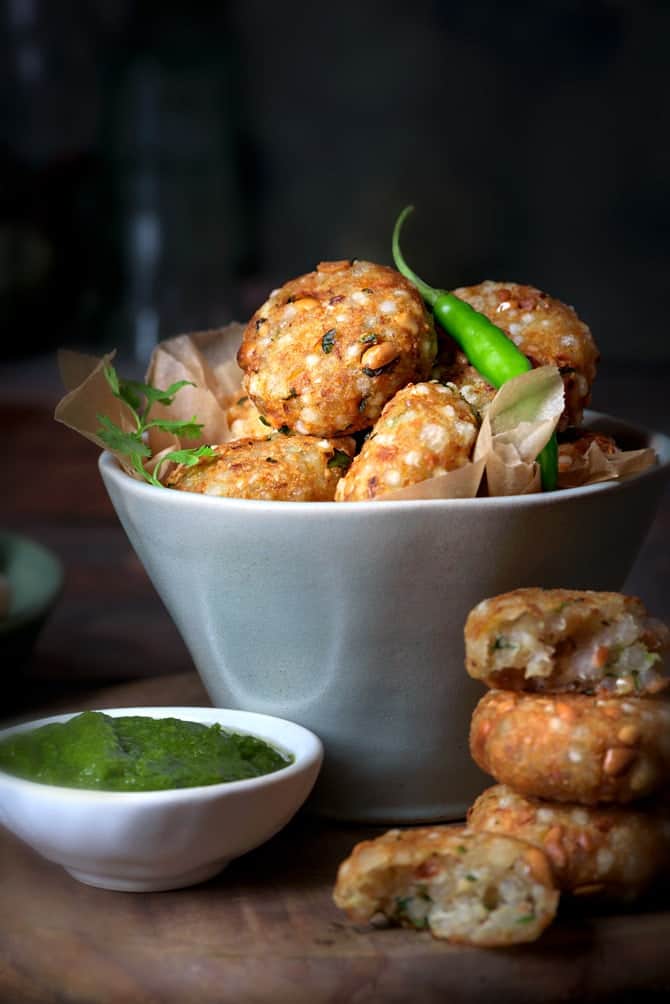 Crispy Sabudana Vada served in a bowl with green chutney on the side.