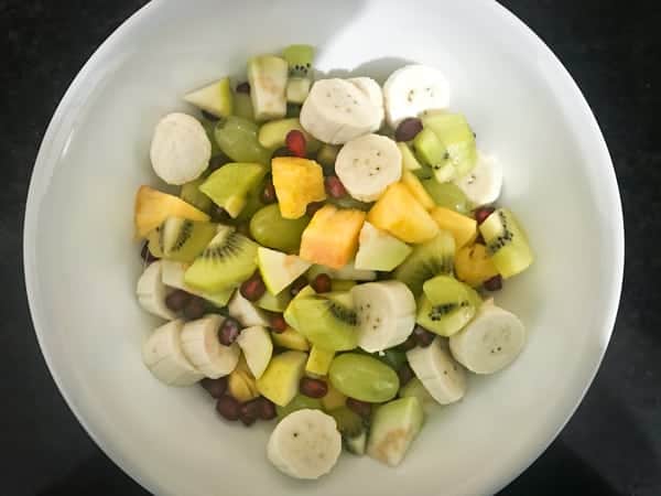 Mixed fruit cubes in a white bowl.