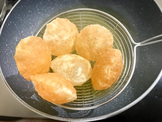 Crisp fried puri of pani puri in a ladle