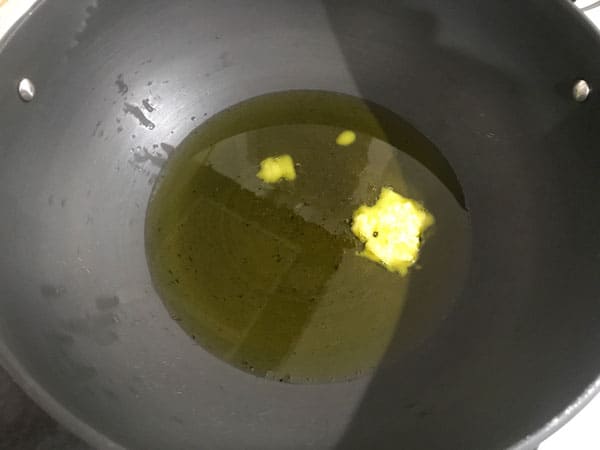 Ghee heating in a pan.