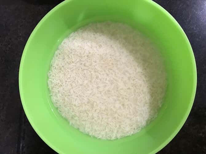 Rice soaking in water in a large bowl