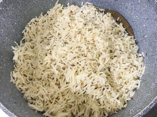 Cooked fluffy jeera rice in pot