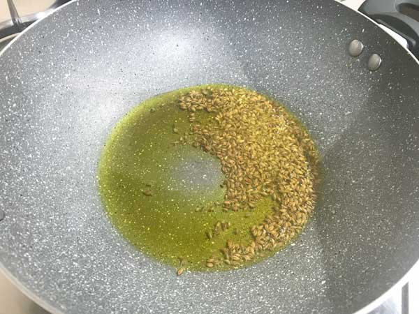 cumin seeds added in hot oil in pan