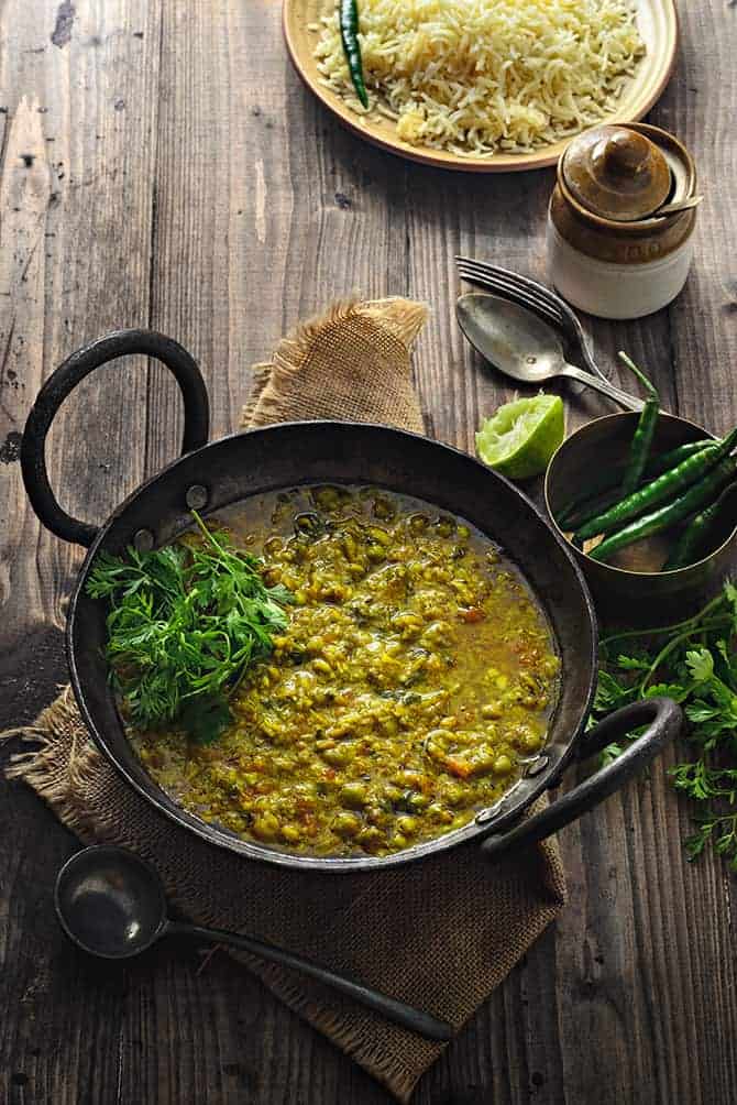 Spicy Matar Ka Nimona in traditional iron kadai with rice on the side.