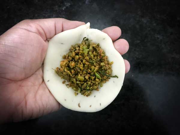 Matar Kachori stuffing placed in the centre of the rolled disc.