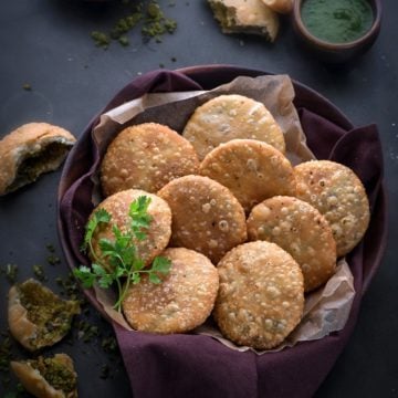 Matar Kachori in large wooden bowl with green chutney on the side