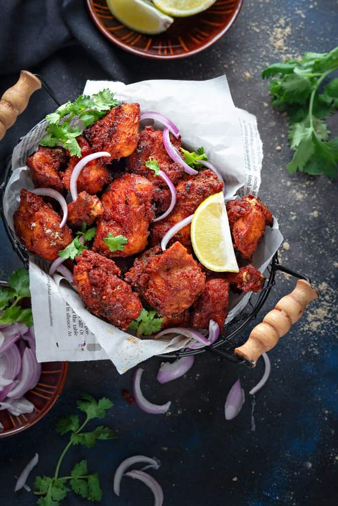 Crisp Chicken Fry kabab served in a basket, onions and lemon on the side