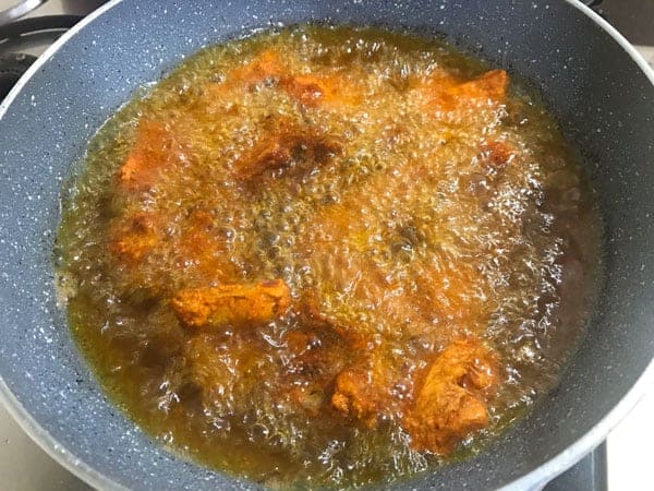 Deep frying the marinated chicken