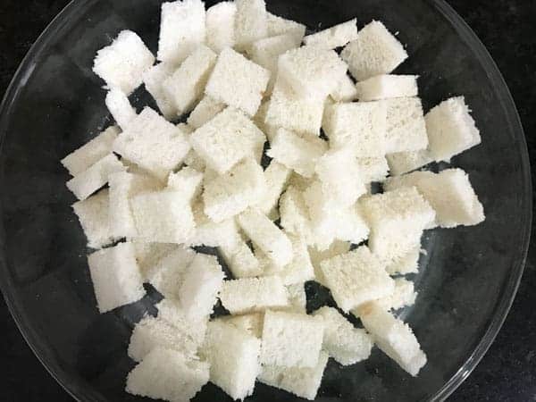 Cubed white bread added in large bowl