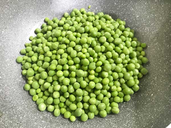 Green peas added in pan with oil