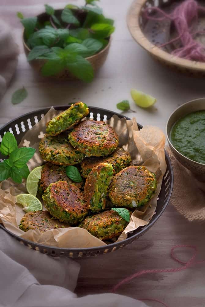 Crisp Paneer Matar Kabab served in a traditional brass bowl with green chutney on the side.