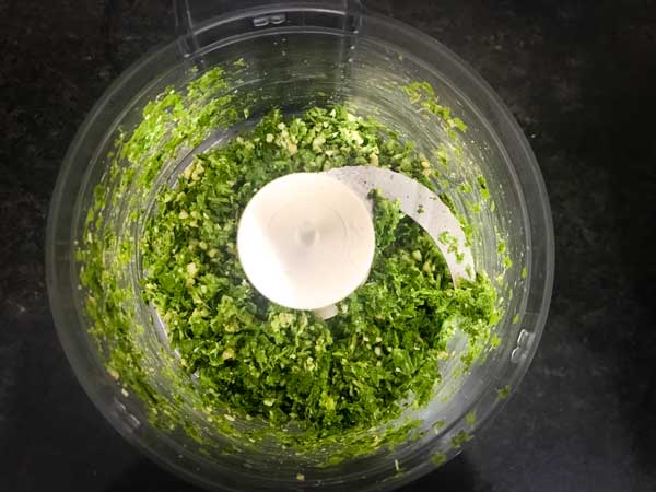 Coarse cashew nuts and green masala mixture in a blender