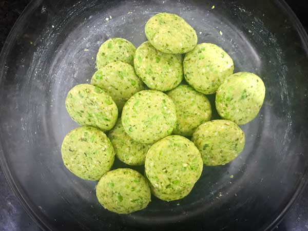 Shaped paneer matar patties in a bowl ready to fry