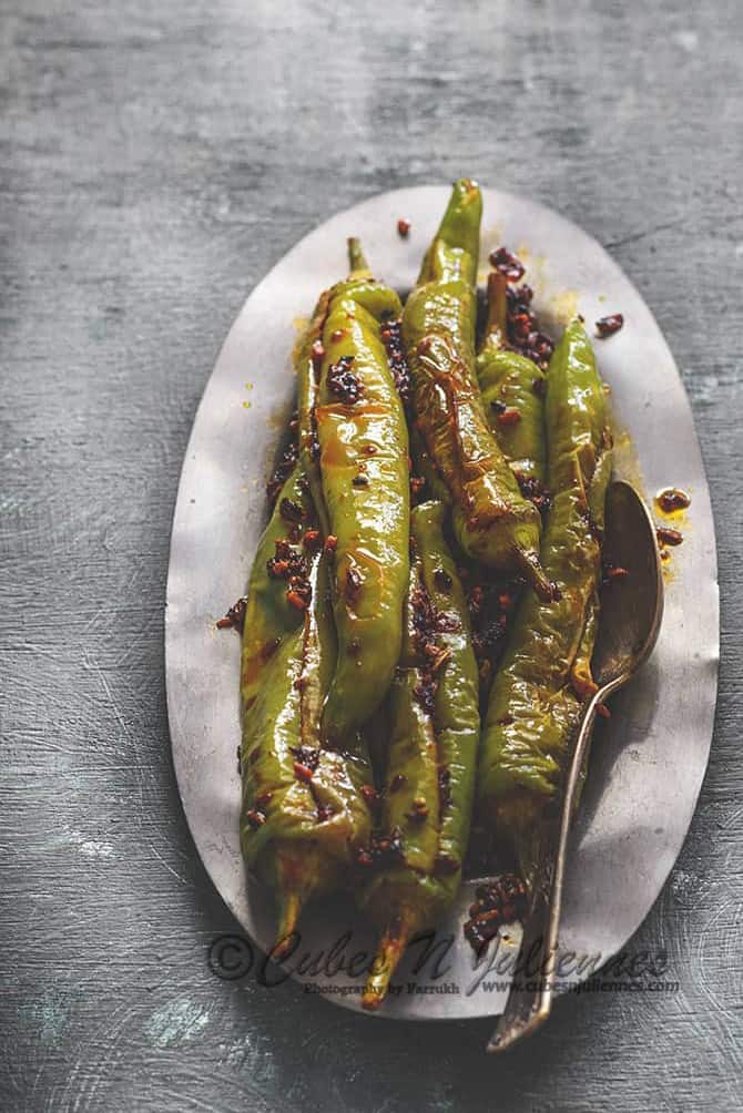 Bharwa mirchi fry served on oval metal plate.