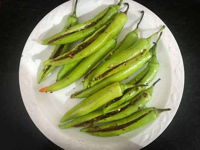 Stuffed green chillies on white plate