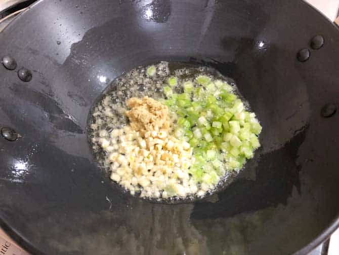 chopped celery, ginger and garlic added in wok to make chicken fried rice recipe