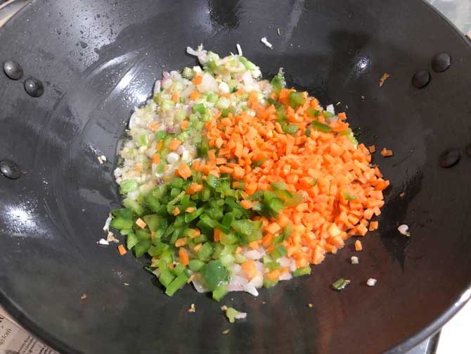 Chopped carrots and capsicum added in wok