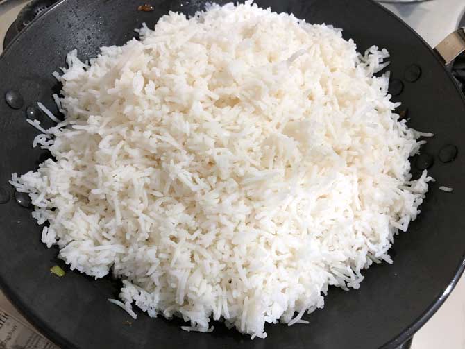 Cooked rice added in wok