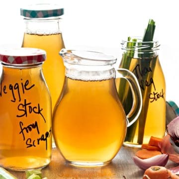 Homemade Vegetable Stock in glass pitcher and glass bottles.