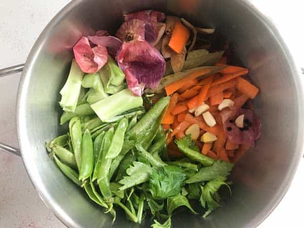 Vegetable scraps, bay leaves, ginger garlic and black peppercorn in pot