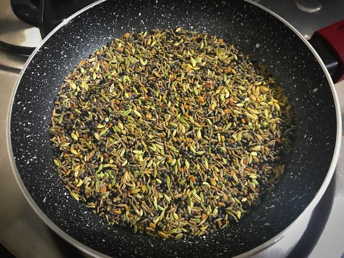 All the seeds roasting in pan for the making of achari masala recipe