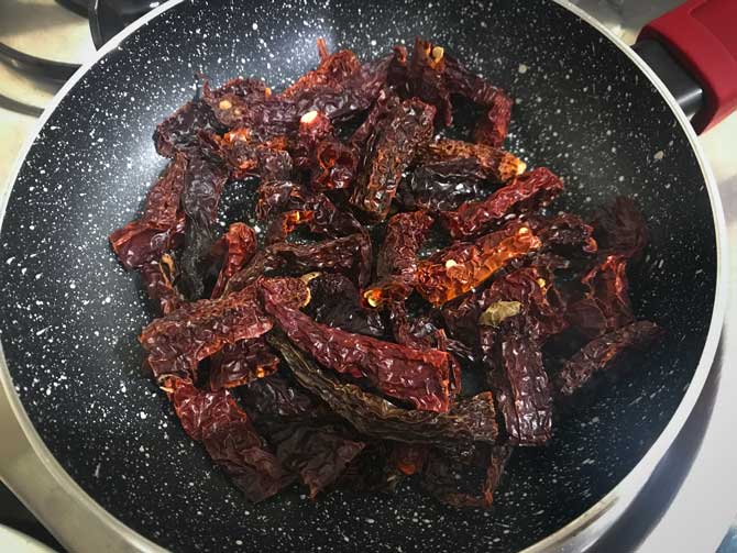 Dried red chilies roasting pan for the making of Achari masala powder