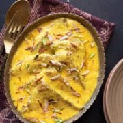 Overhead shot of Hyderabadi Shahi Tukda or Shahi Toast served in oval brass platter.