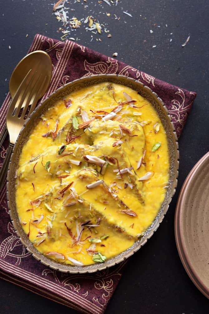 Overhead shot of Hyderabadi Shahi Tukda or Shahi Toast served in oval brass platter.