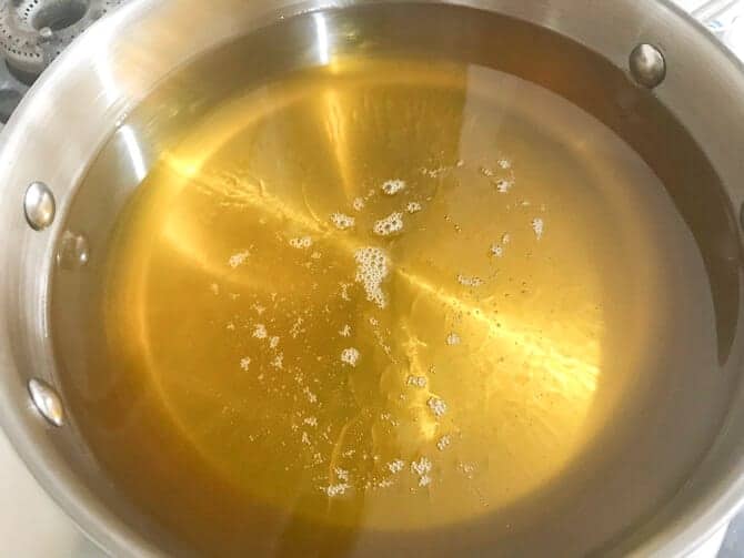 Oil heating in a deep pan.