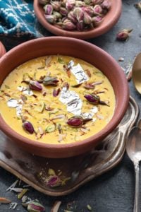 Close up shot of kesar Rabdi or sweetened condensed milk served in earthen pot.