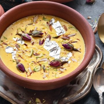 Close up shot of kesar Rabdi or sweetened condensed milk served in earthen pot.