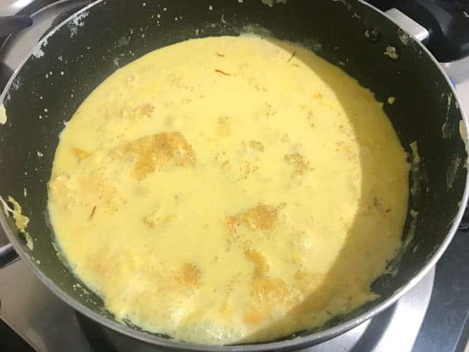 Sugar and scraped cream from the sides added back to kesar rabdi in pan