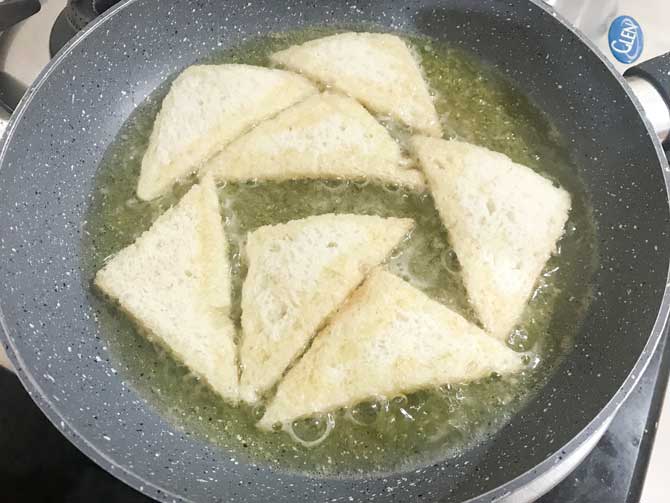 Triangular bread slices frying in ghee for shahi tukda recipe