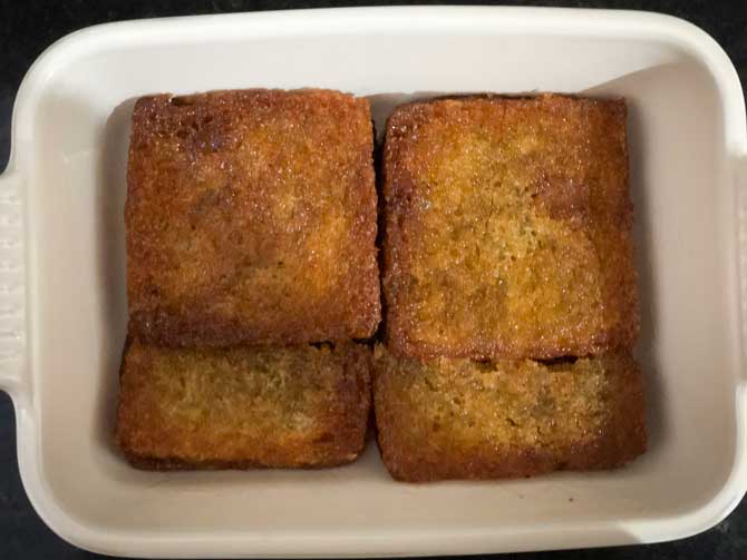 Fried and soaked bread layered in a dish for Delhi style shahi tukda recipe