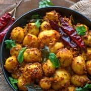 Close up shot of spicy roast baby potatoes served in black plate