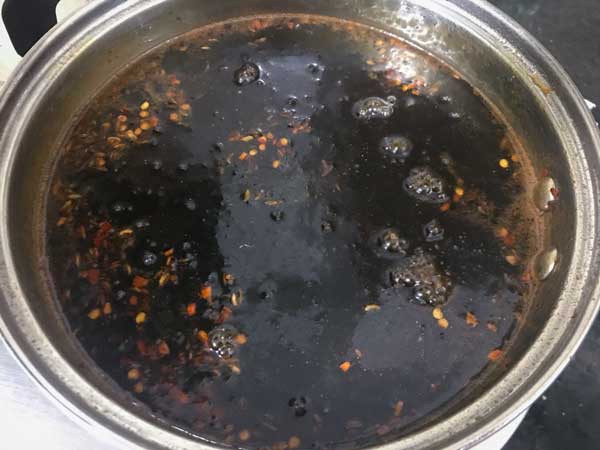 Sweet and Spicy tamarind chutney or imli chutney ready in pan.