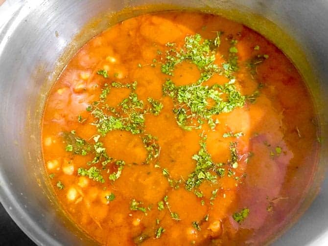Cooked chana masala curry in pot.
