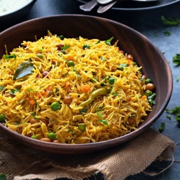 Semiya upma or vegetable vermicelli upma in wooden bowl, spoons and chutney at the back.