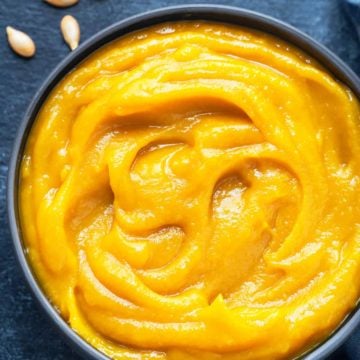 Close up shot of homemade pumpkin puree in blue bowl.