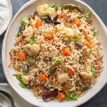 Close up shot of mix veg pulao or vegetable pulao on white ceramic plate.