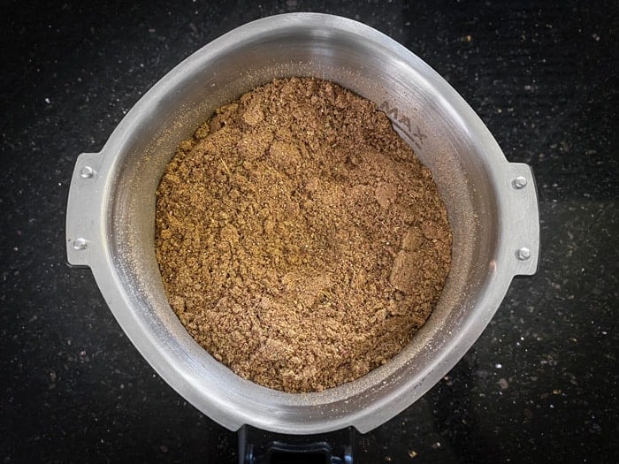 Powdered chai masala in a blender jar.