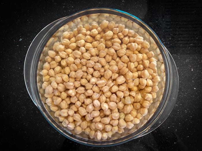 Soaked chickpeas in glass bowl.