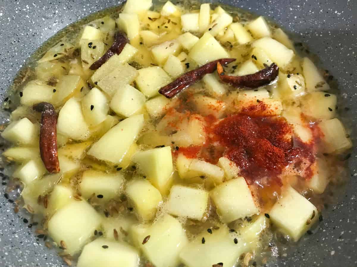 Water, salt and red chilli powder added in pan.